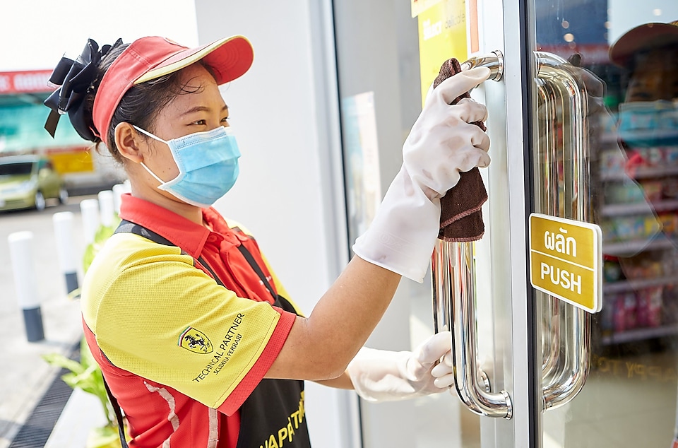Shell Staff at shell station cleaning glass door