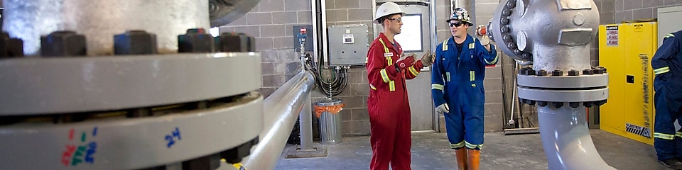 Two engineers at the Dawson Creek Reclaimed Water Project facility