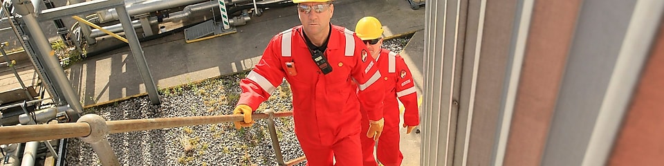 Shell engineers walking up stairway at a plant