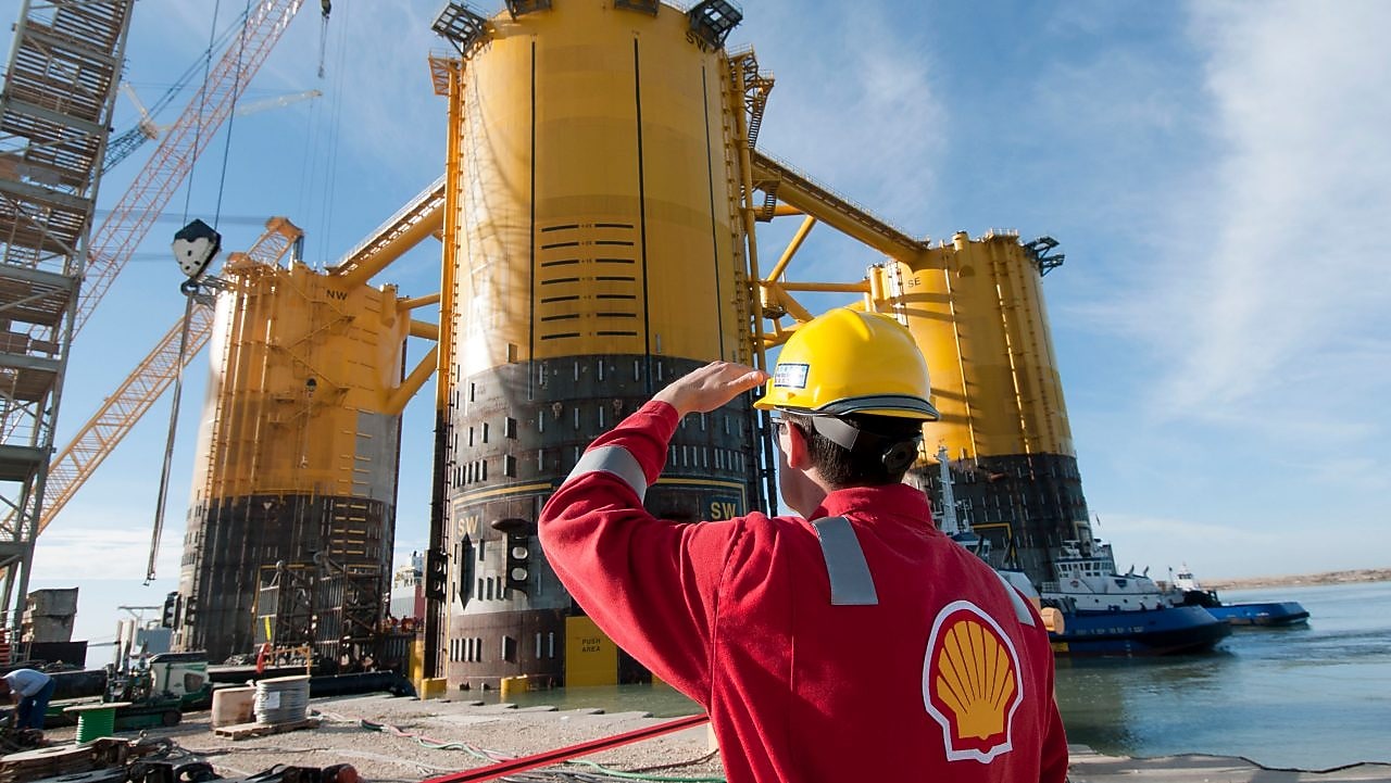 Engineer looking up at platform under construction