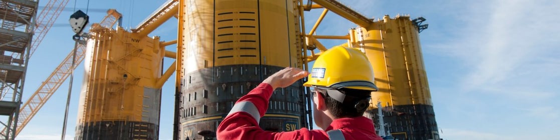 Engineer looking up at platform under construction