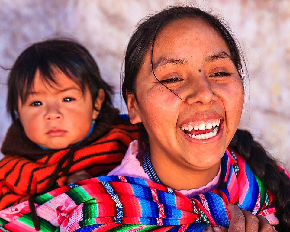 Peruvian woman with her baby on her back