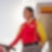 a woman holding an oil dispenser in service station