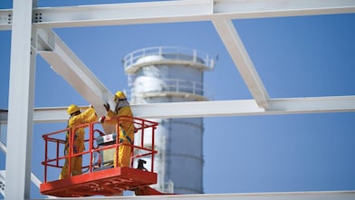 Two engineers on crane doing maintenance work