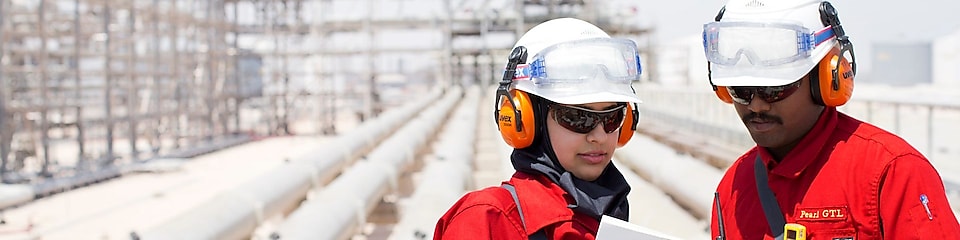 A field operator supporting a young Qatari Engineer